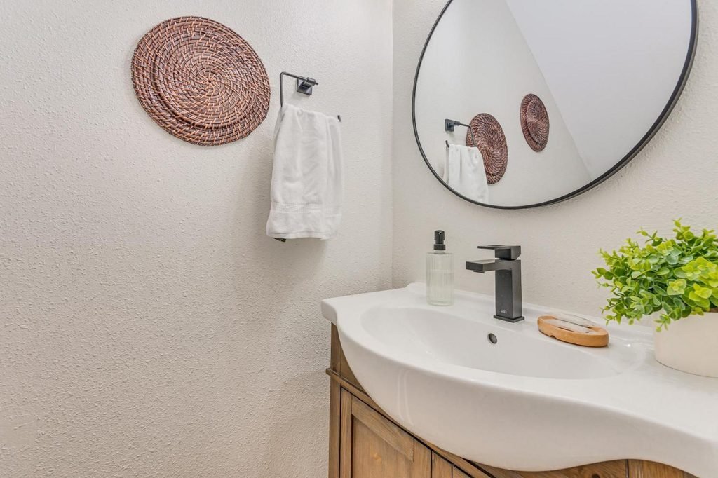 Clean guest bathroom with fresh hand towels and essential toiletries